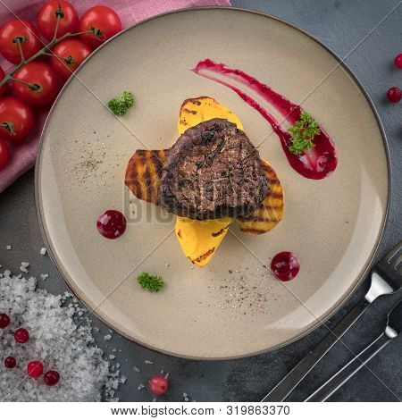 Steak Filet Mignon With Smoke. Baked Potatoes And Cranberry Sauce. ?herry Tomatoes. Grey Background