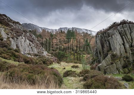 Stunning Dramatic Landscape Images Of Ogwen Valley In Snowdonia During Winter With Snowcapped Glyers