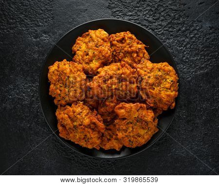 Indian Takeaway Food, Spicy Onion Bhajis On Black Plate