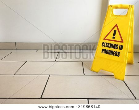 Cleaning In Progress Caution Yellow Sign On Office Floor