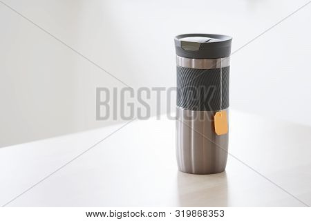 Travel Thermal Flask And Hot Tea Drink With Orange Bag String Hanging For Travellers In Outdoors Wit