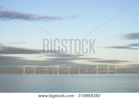 Wind Farm In North Sea Ocean Floating Turbines On Horizon Offshore At Aberdeen To Generate Energy An