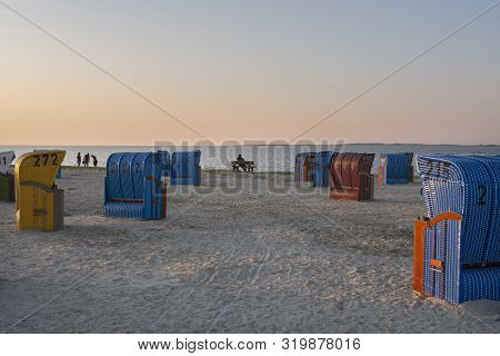 Beach Korbs On The Coast Of Northern Germany In Warm Evening Sunlight