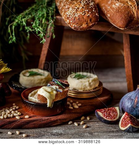Soft Spreadable French Stinky Cheese On A Slice Of Bread With Fruit And Pine Nuts, Square