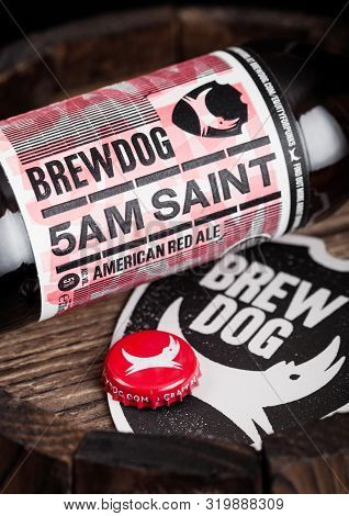 London, Uk - August 10, 2018: Brewdog 5am Saint Beer Coaster With Bottle Top And Bottle On Wood Barr