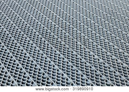 Diagonal View Of Perforated Surface Made Of Rubber, Metal Or Plastic Material With Detailed Pattern