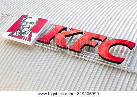 Minsk, Belarus - July 20, 2019: Kfc Fast Food Restaurant Logo On White Gugate Facade Background, Dia