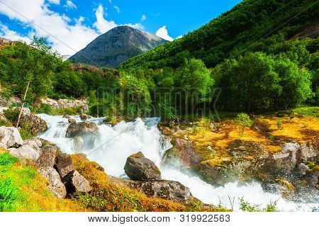 Mountain River In Jostedalsbreen National Reserve Near Briksdal Glacier, Norway. Summer Landscape.