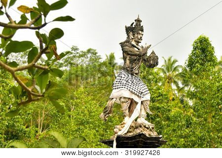 Hindu Statue In Front Of The Balinese Temple.