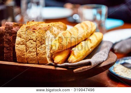 Basket With Different Bread On The Table In The Restaurant