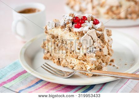 Kiev Cake Or Daquoise Meringue Cake With Butter Cream On Plate With Dessert Fork And Cup Of Espresso