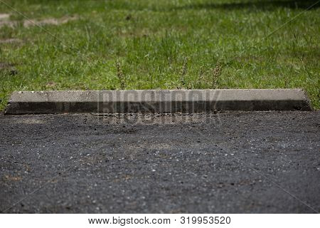 Close Up Of A Parking Bumper In A Lot