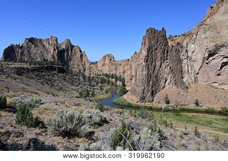 Smith Rock State Park And Crooked River Near Town Of Terrebonne, Oregon On Cloudless Summer Day.