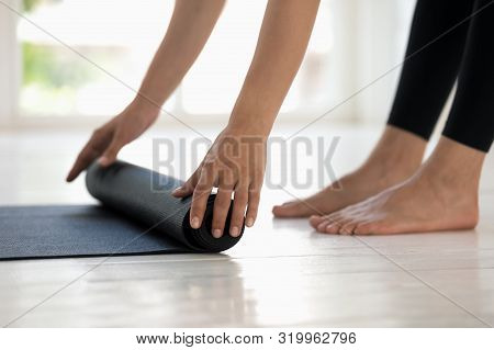 Woman Practicing Yoga, Rolling Black Mat Side View Close Up