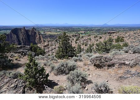 View Of Terrebonne And Distant Volcanoes From Misery Ridge Trail In Smith Rock State Park, Oregon On