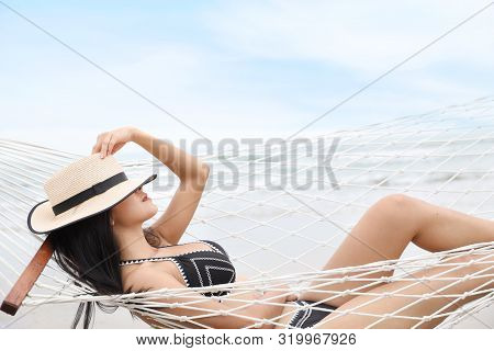 Side View Sexy Asian Woman In Black And White Bikini And Hat Who Lying And Sleeping In A Hammock On 