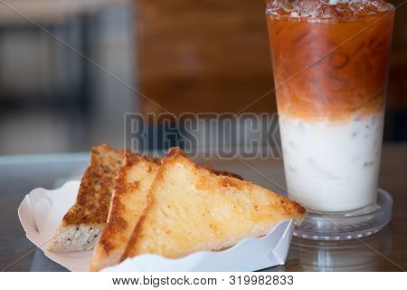 Garlic Bread In White Paper Tray Served With Thai Milk Tea In The Breakfast