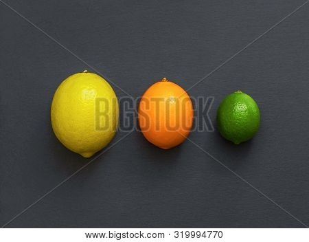 Citrus Fruit On A Stone Table. Juicy Ripe Lemon, Citrus Meyeri And Lime On Grey Background. Food Bac