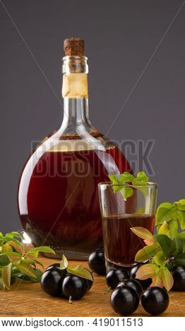Jaboticaba, Bottle And Glass Of Homemade Brazilian Jaboticaba Liqueur On Wood With Leaves And Branch