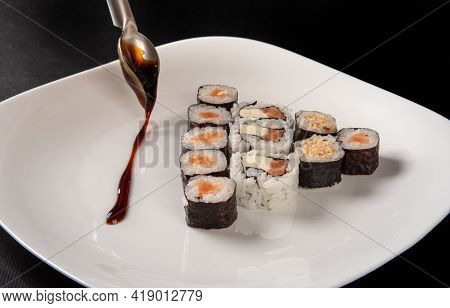 Sushi, Beautiful Sushi Arrangement Decorated With Tare Sauce On A White Plate On A Dark Surface, Bla