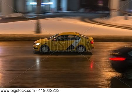 Fast Moving Yandex Taxi Car With Motion Blur Effect. Overspeed Concept. Motion City Street Scene Wit