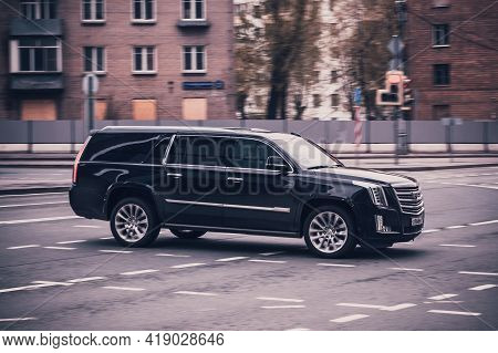 Black Cadillac Escalade Esv Car Moving On The Street On High Speed. Fast Moving Black Suv Car On The