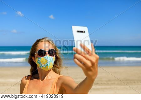 Funny Girl Taking Selfie Photo By Smartphone On Tropical Sea Beach. New Rules To Wear Cloth Face Cov