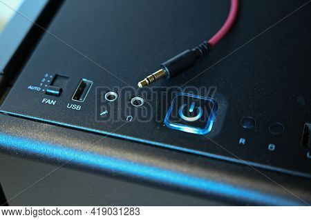 A Red Cable With A Mini Jack Connector Lies On The Computers System Unit Near The Headphone Jack