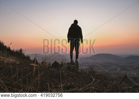 Silhouette Of A Teenager And Athlete Jumping On A Tree Stump And Doing A Straddle Vault, Splits At S