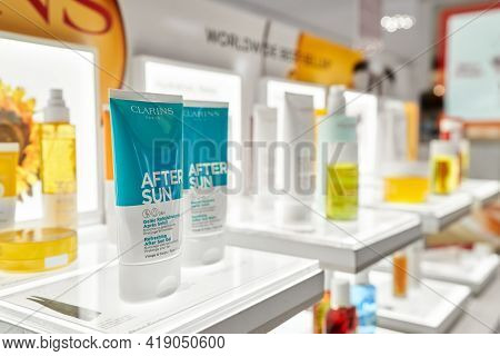 Clarins Beauty Products Set On Shelf Of Rinascente In Milan, Refreshing After Sun Gel. Clarins Is Fr