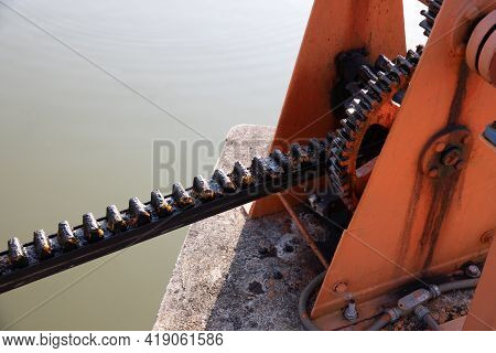 Metal Mechanical Gear On The Floodgate. Water Lock Gate Control Gears. Gears Of The River Flood Dam.