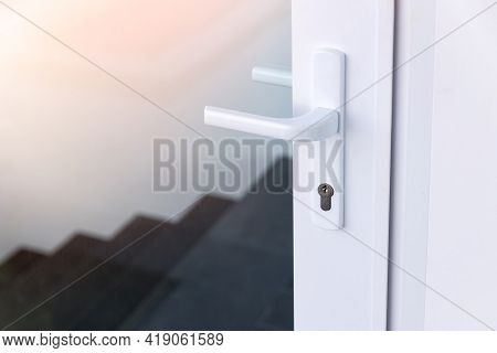 Exterior Door Handle And Security Lock On Metal Frame. Aluminum Door Knob. Modern White  Door With M
