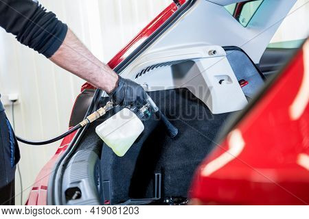 A Car Service Worker Cleans Interiror With A Special Foam Generator