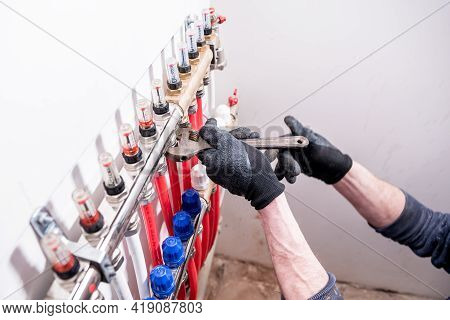 Pipefitter Install System Of Underfloor Heating System At Home