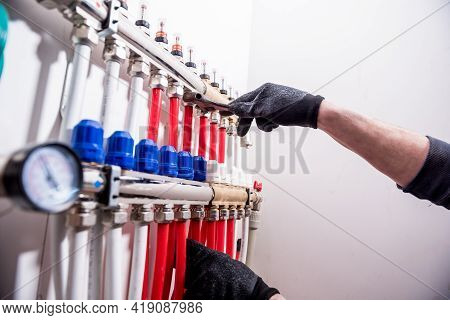 Pipefitter Install System Of Underfloor Heating System At Home