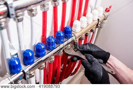 Pipefitter Install System Of Underfloor Heating System At Home