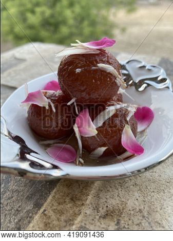 Delicious Gulabjamun. \nfried Milk Solid Balls Soaked In Fragrant Sugar Syrup.