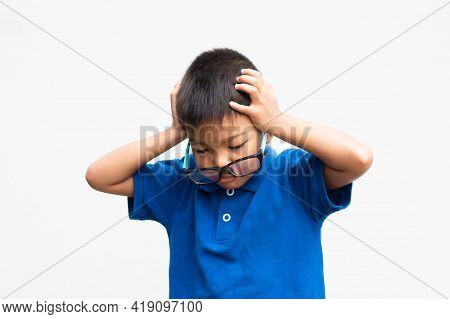 Portrait Image Of 4-5 Years Old Kid. Asian Child Boy Feel Doubt And Stressed. He Wearing A Blue Shir