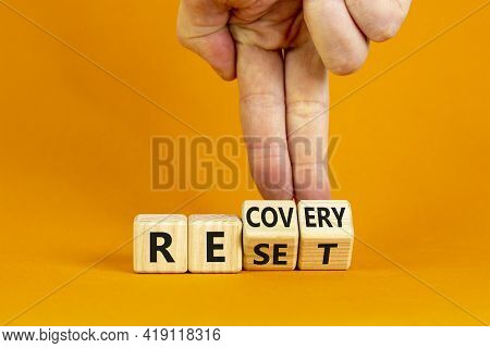 Recovery And Reset Symbol. Businessman Turns Cubes And Changes The Word 'recovery' To 'reset'. Beaut