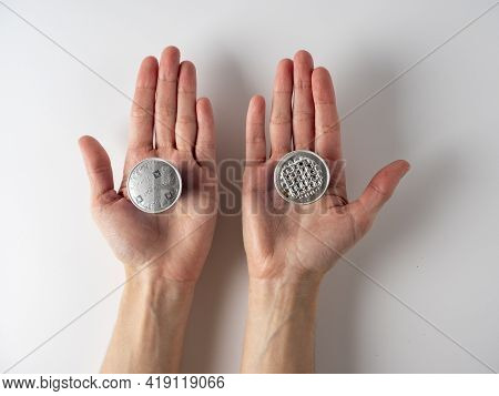 I10.03.2021 Russia, Moscow. N His Hands Are Two Aluminum Capsules With Ground Nespresso Coffee . One