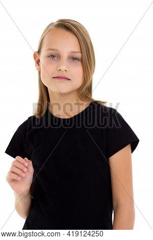 Pretty Blonde In A Black T-shirt. Girl In Fashionable Clothes Posing In The Studio. Close Up Portrai