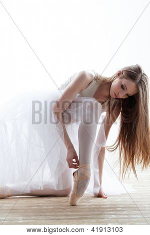 young beautiful dancer posing on a studio background