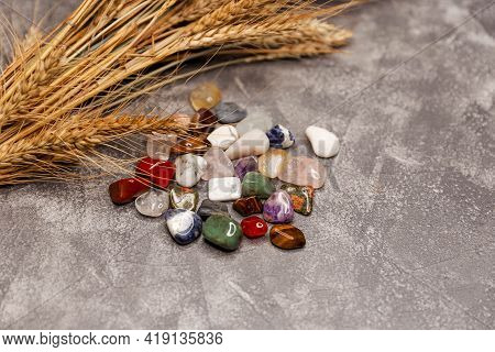 Row Of Multicoloured Healing Crystals On Grey Background. Various Healing Stones. Composition Of Eso