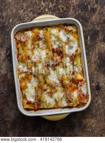 Fresh Cannelloni Pasta With Spinach And Ricotta Baked With Mozzarella Cheese In A Baking Dish On A W