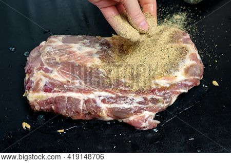Homemade Capicola. Dry-cured Pork Loin Step-by-step Recipe. A Hand Sprinkles A Salted Piece Of Meat 