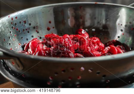 Fresh Thawed Seedless Cherries In A Metal Colander. Close-up Of Ripe Berries Ready To Eat. Berries F