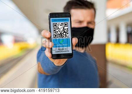health Vaccine Passport for Coronavirus or Covid-19. Traveller Using Mobile Phone with Vaccination in Immune Status to Certificated International Traveling in train station