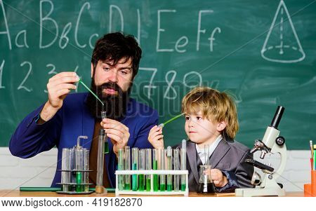 Bearded Man Teacher With Little Boy. Father And Son Child At School. Laboratory Test Tubes And Flask