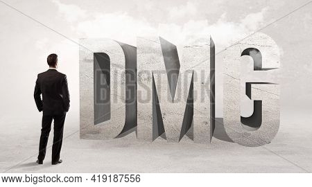 Rear view of a businessman standing in front of abbreviation