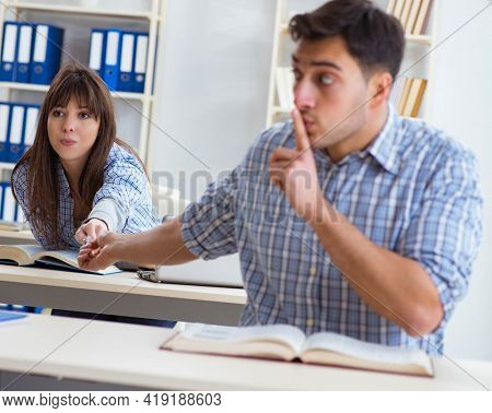 Students sitting and studying in classroom college